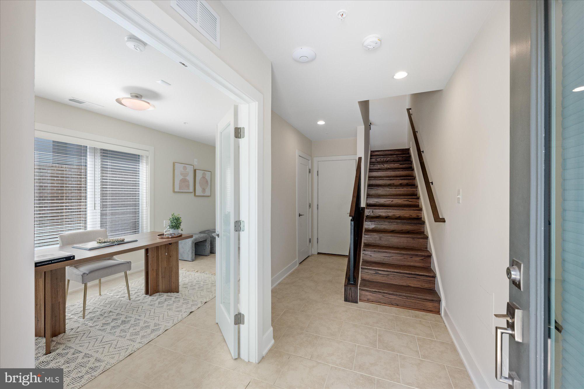 6597 Rock Spring Drive Bethesda, MD 20817 - Photo 3 of 37 an entryway with a workspace and windows