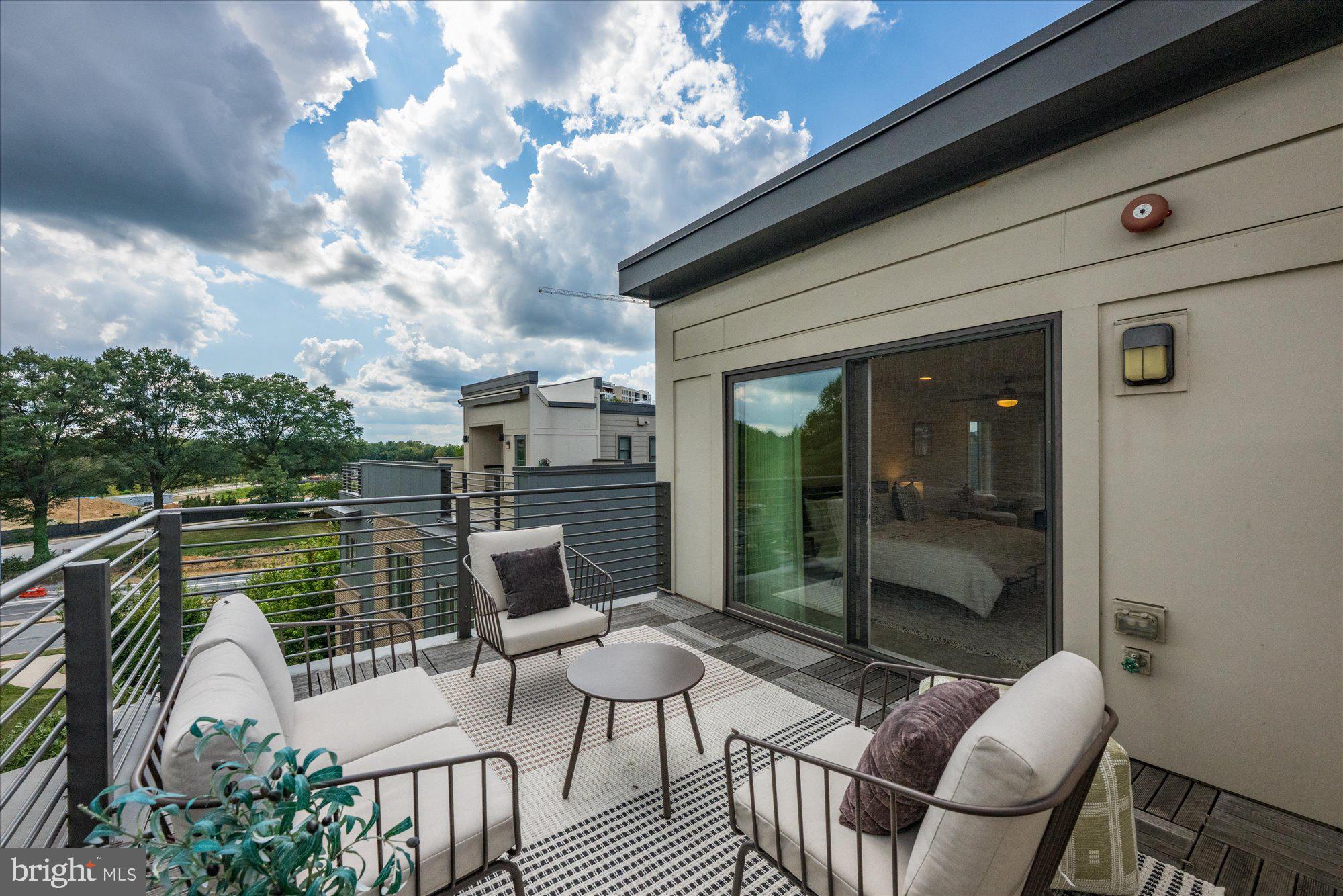 6597 Rock Spring Drive Bethesda, MD 20817 - Photo 34 of 37 a view of a patio with couches table and chairs and potted plants