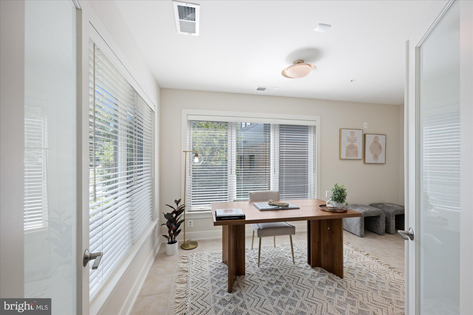 6597 Rock Spring Drive Bethesda, MD 20817 - Photo 4 of 37 a workspace with furniture and a potted plant