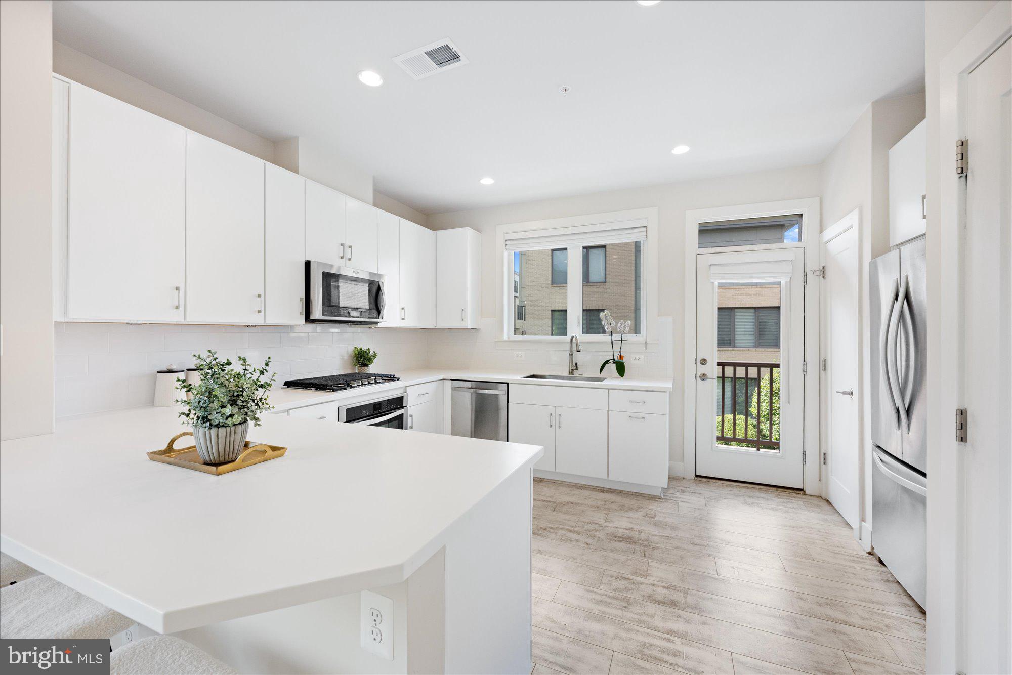 6597 Rock Spring Drive Bethesda, MD 20817 - Photo 6 of 37 a kitchen with a sink cabinets and window