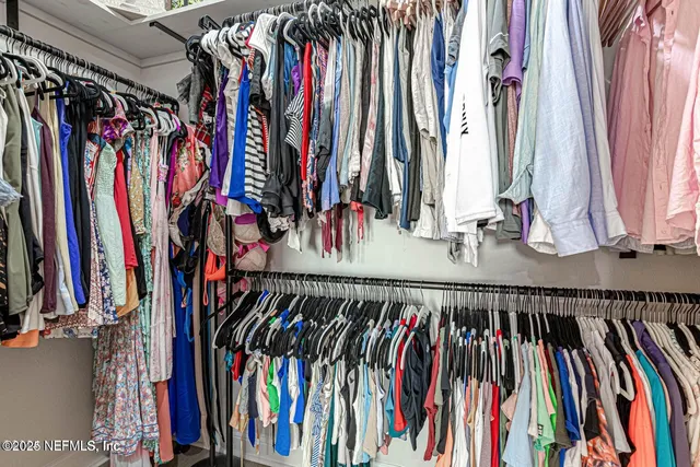 a living room with furniture a flat screen tv and a table
