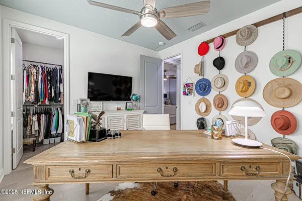 a view of patio with a table and chairs and potted plants