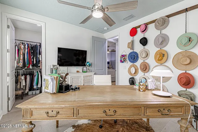 a view of patio with a table and chairs and potted plants
