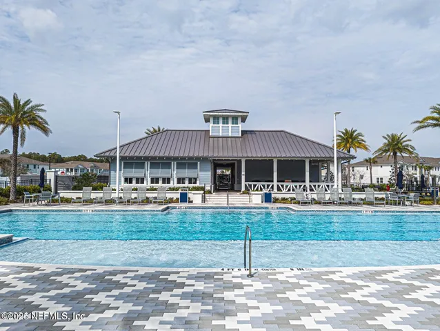 a view of a house with a yard patio and swimming pool