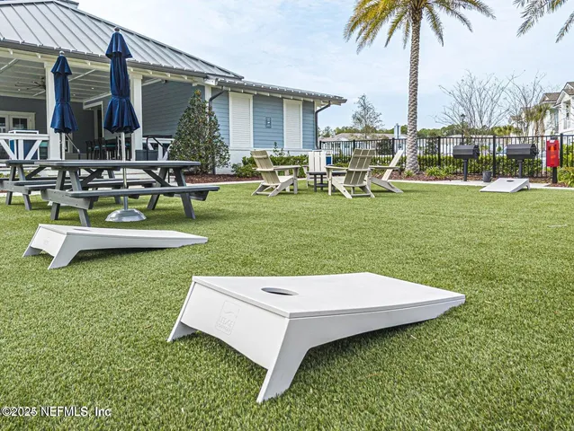 a living room with lots of furniture and a floor to ceiling window