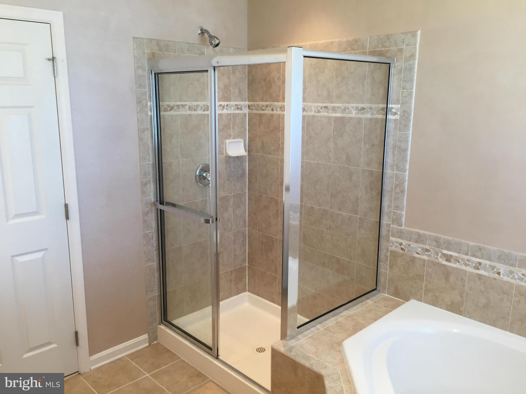 26 Riparian Lane Ranson, WV 25438 - Photo 16 of 28 a bathroom with a shower and a sink