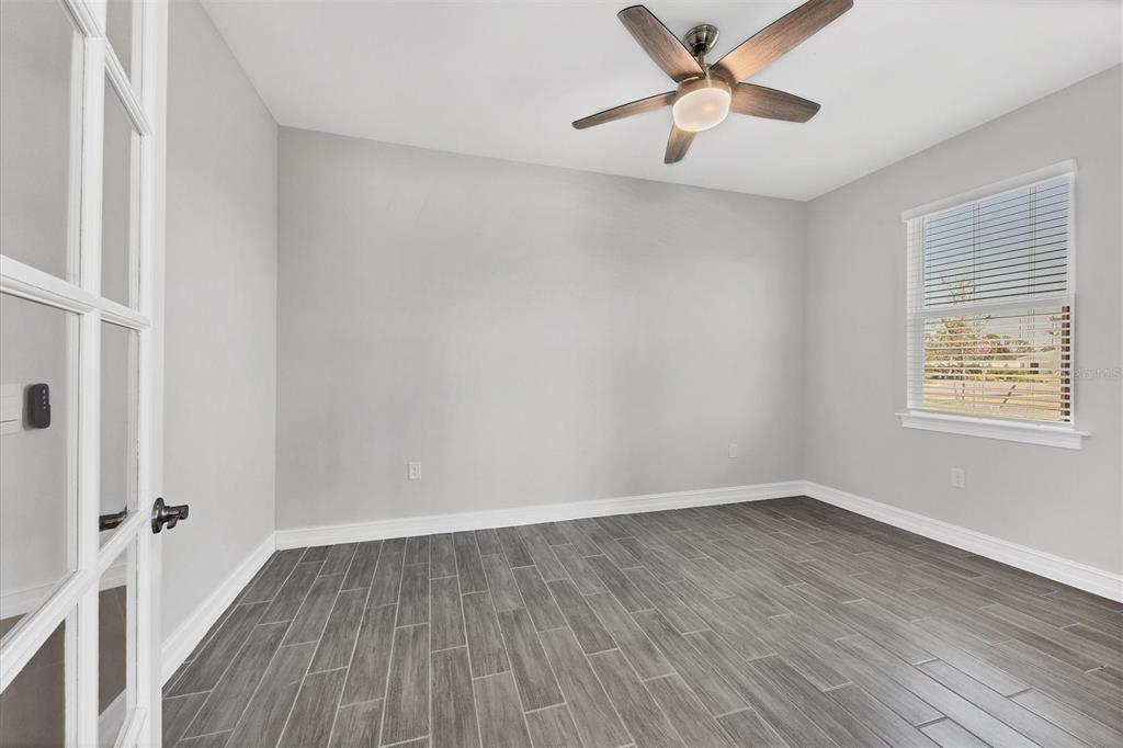111 Ibiza Loop Venice, FL 34292 - Photo 18 of 37 wooden floor in an empty room with a window