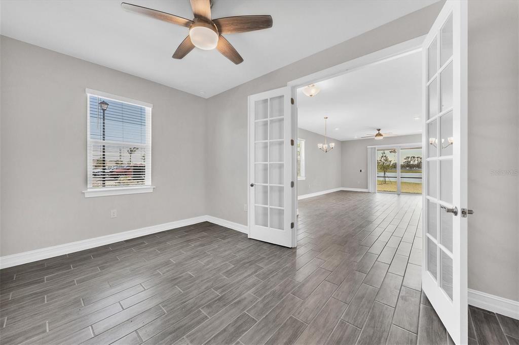 111 Ibiza Loop Venice, FL 34292 - Photo 19 of 37 a view of an empty room with wooden floor and a window