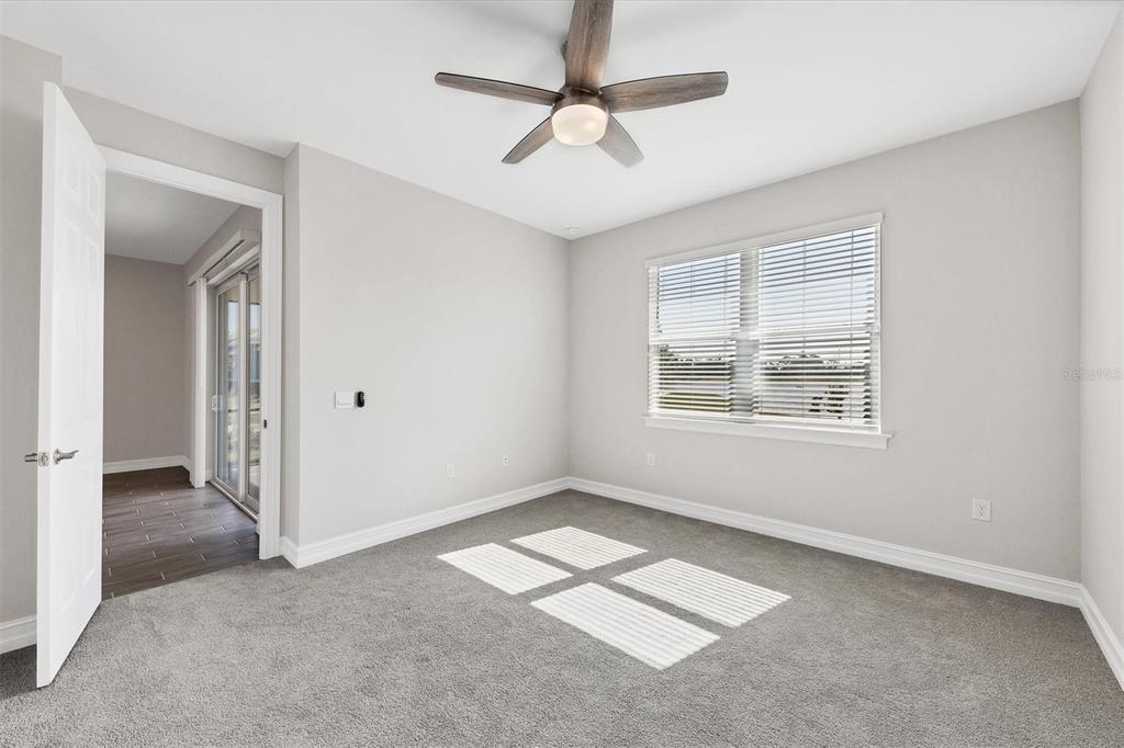 111 Ibiza Loop Venice, FL 34292 - Photo 21 of 37 an empty room with windows and fan