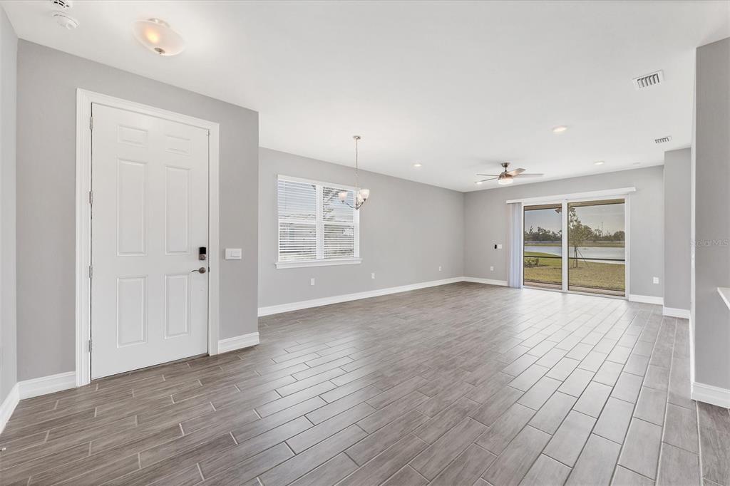 111 Ibiza Loop Venice, FL 34292 - Photo 4 of 37 an empty room with wooden floor and windows