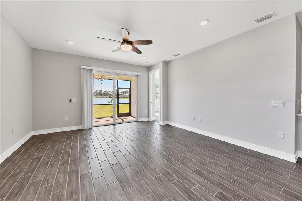 111 Ibiza Loop Venice, FL 34292 - Photo 9 of 37 a view of empty room with wooden floor and fan