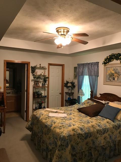 3623 Yager Road McMinnville, TN 37110 - Photo 11 of 16 a bedroom with a bed and a chandelier