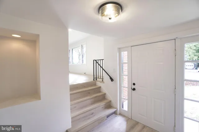a view of an entryway with wooden floor