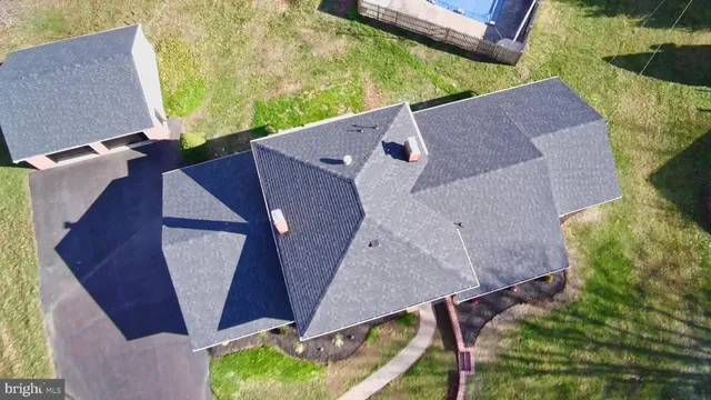 an aerial view of a house with a yard