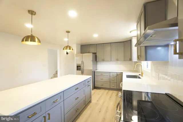 a spacious bathroom with a sink a large mirror and a shower