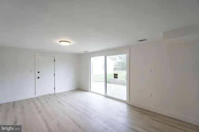 a view of a livingroom with a fireplace wooden floor and window
