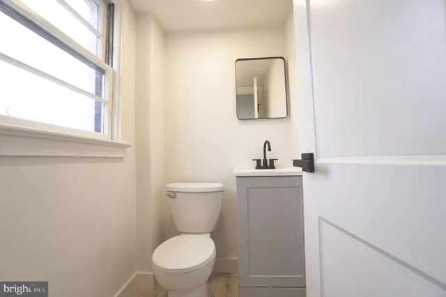 a view of empty room with wooden floor and fireplace