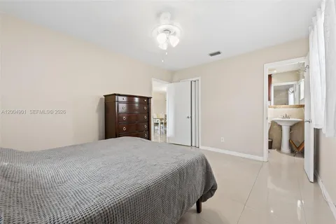 a spacious bedroom with a bed and a walk in closet