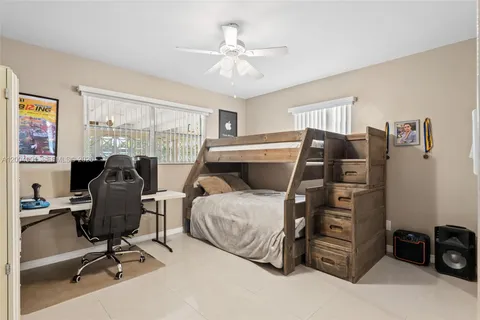 a bedroom with furniture and a ceiling fan