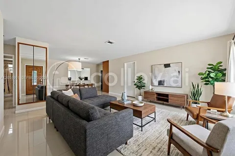 a living room with furniture or couch and a potted plant