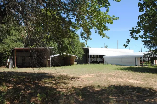 a view of a backyard with sitting area