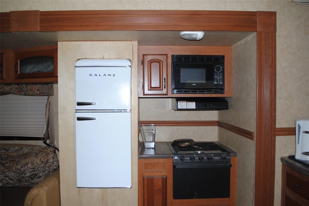 23 Promontory Port Comanche, TX 76442 - Photo 13 of 23 a kitchen with a stove and a refrigerator