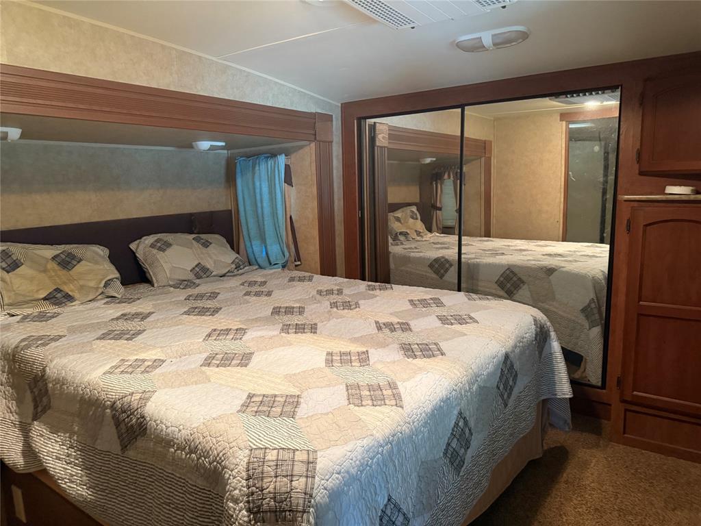 23 Promontory Port Comanche, TX 76442 - Photo 14 of 23 a large bed sitting in a bedroom next to a window