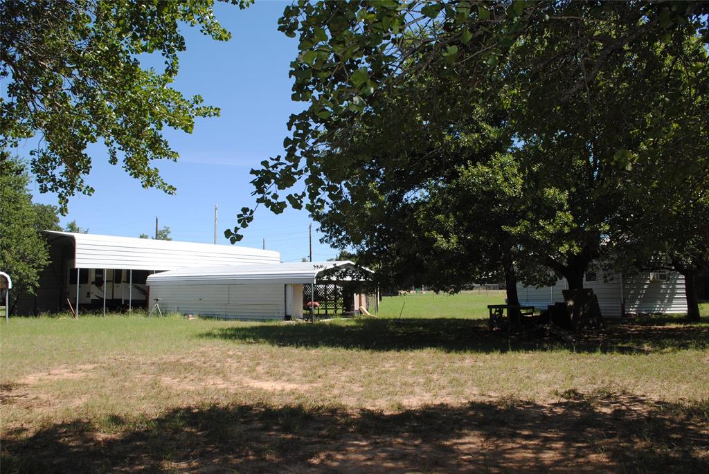 23 Promontory Port Comanche, TX 76442 - Photo 7 of 23 a view of a white house with a yard and sitting area