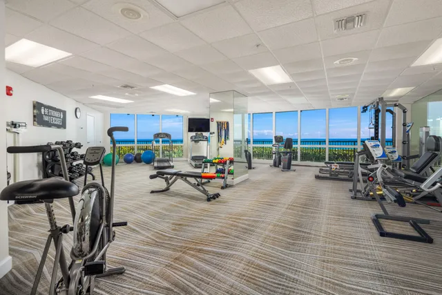 a living room with a floor to ceiling window and wooden floor