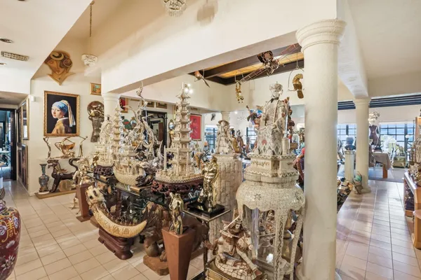 a view of a dining room with furniture and chandelier