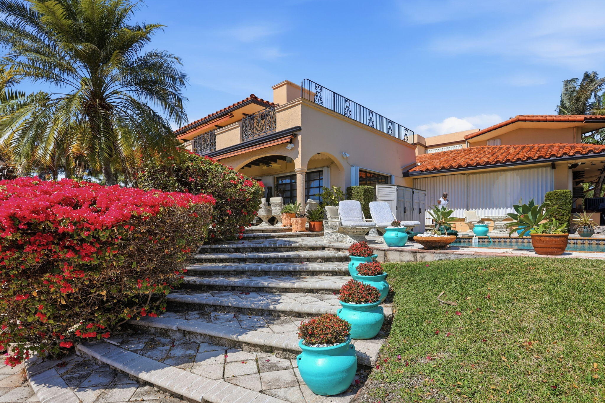 2850 Northeast 44th Street Lighthouse Point, FL 33064 - Photo 39 of 67 a front view of a house with fountain and outdoor seating