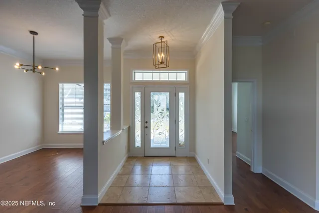 a view of a hallway with wooden floor windows and livingroom