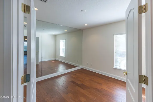 a view of a livingroom with a ceiling fan and window