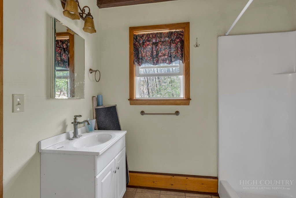 179 Soave Ridge Deep Gap, NC 28618 - Photo 22 of 31 a bathroom with a sink and a mirror