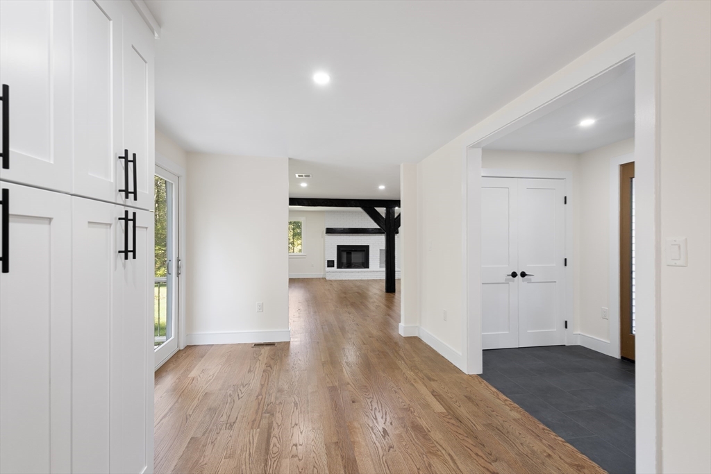 241 Prospect Street Franklin, MA 02038 - Photo 12 of 42 a view of a hallway with wooden floor and a bathroom