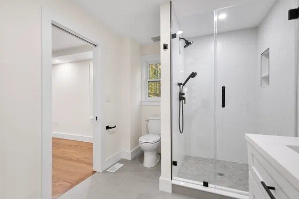 a bathroom with a shower toilet and sink