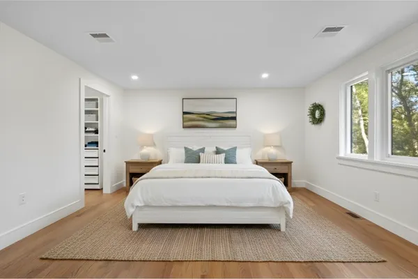 a spacious bedroom with a large bed and a window