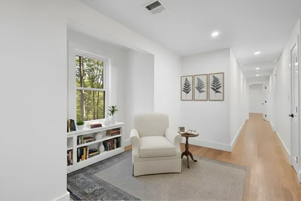 a living room with furniture a window and a potted plant
