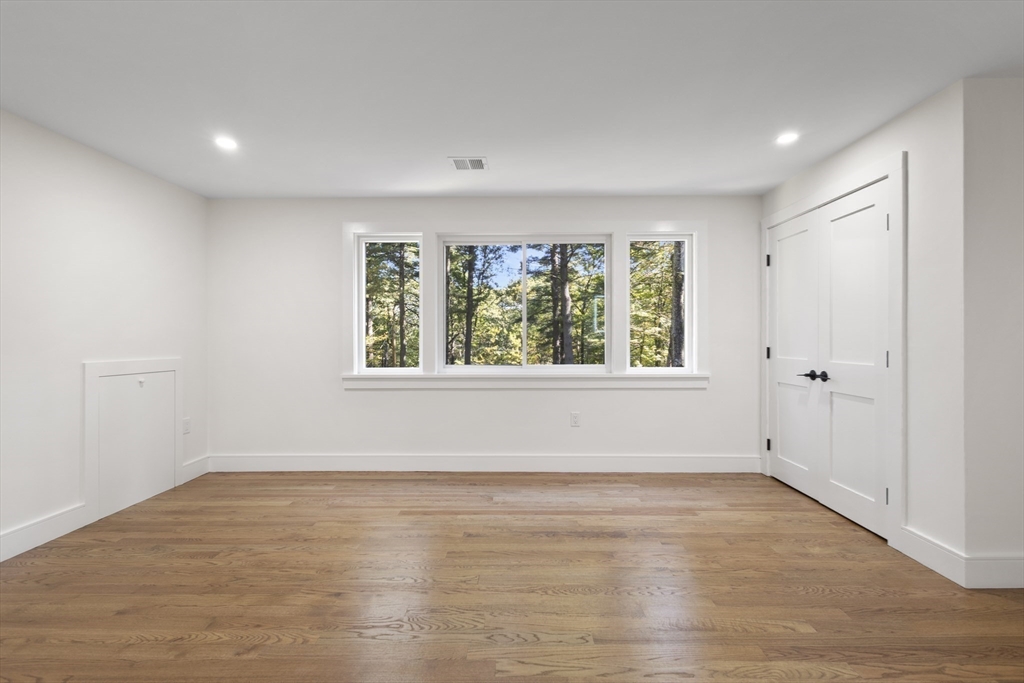 241 Prospect Street Franklin, MA 02038 - Photo 23 of 42 an empty room with wooden floor and windows