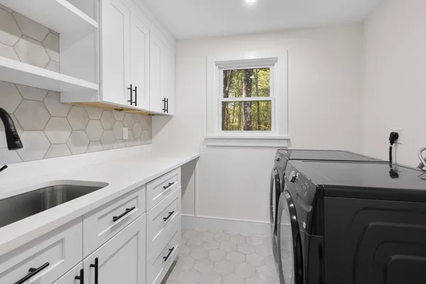 a view of a kitchen with sink and washing machine