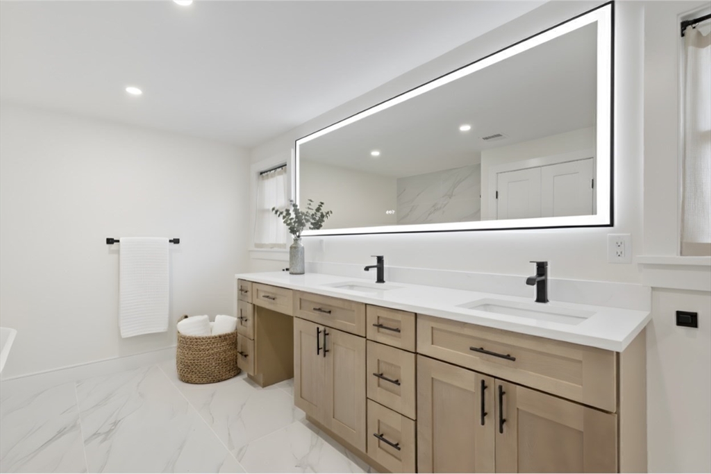 241 Prospect Street Franklin, MA 02038 - Photo 26 of 42 a bathroom with a double vanity sink and a mirror