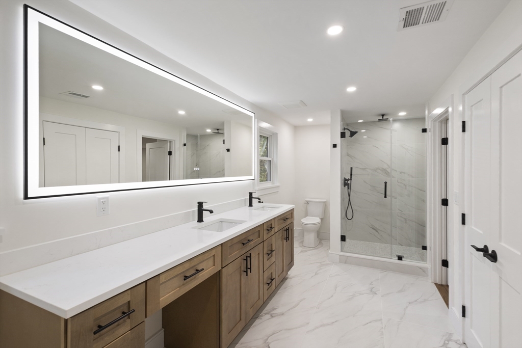 241 Prospect Street Franklin, MA 02038 - Photo 27 of 42 a spacious bathroom with a double vanity sink mirror double and shower