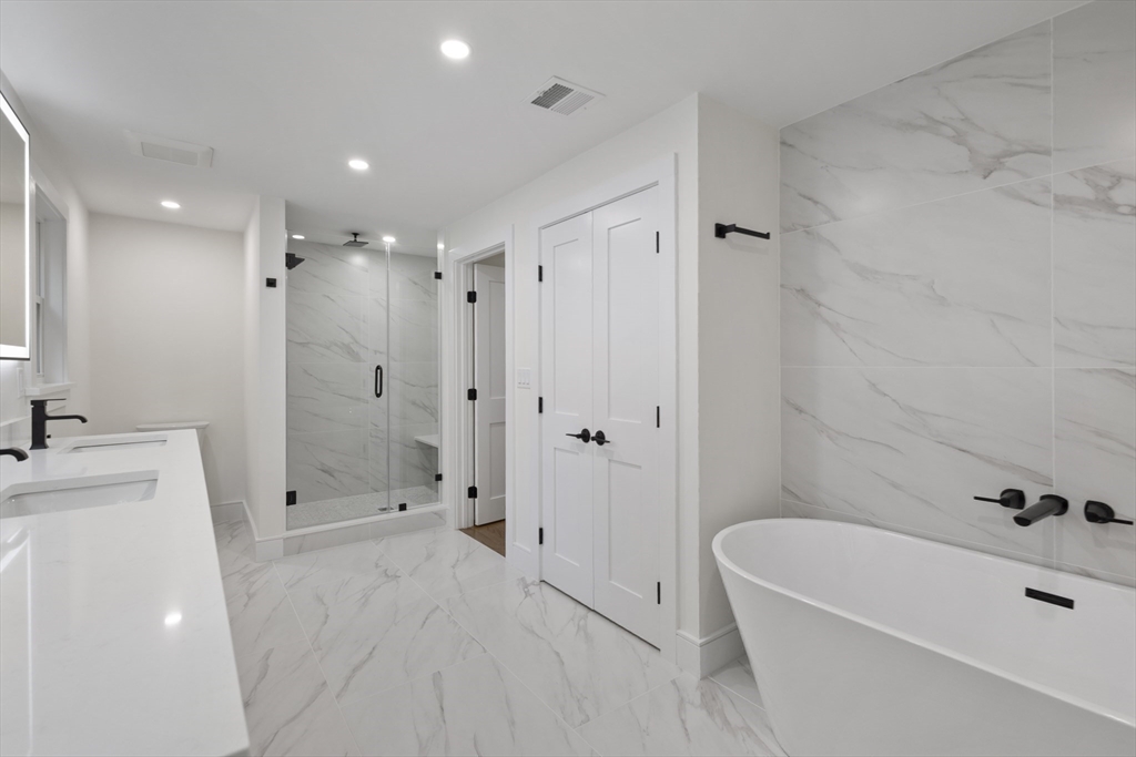241 Prospect Street Franklin, MA 02038 - Photo 28 of 42 a bathroom with a tub a sink a shower and a mirror