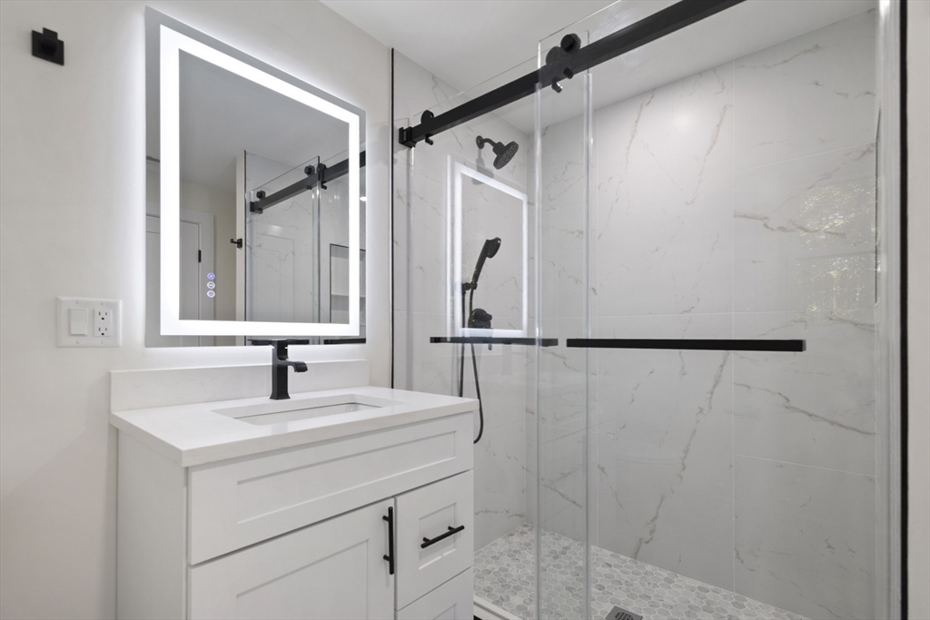 241 Prospect Street Franklin, MA 02038 - Photo 30 of 42 a bathroom with a sink and a mirror