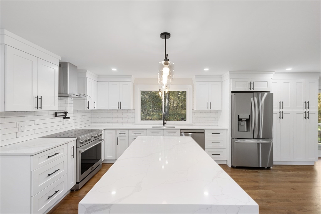 241 Prospect Street Franklin, MA 02038 - Photo 3 of 42 a kitchen with refrigerator a sink and wooden cabinets