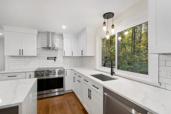 a kitchen with stainless steel appliances a stove sink and cabinets