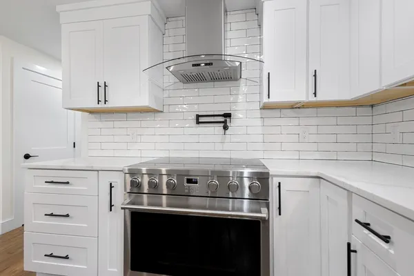 a stove top oven sitting inside of a kitchen