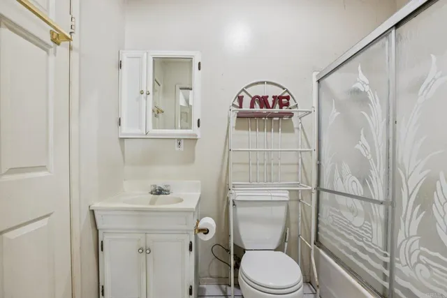 a bathroom with a toilet sink and shower