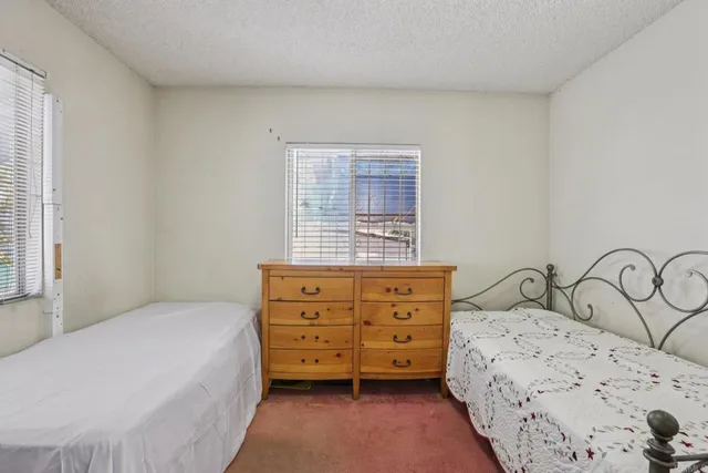 a bedroom with a bed and a dresser