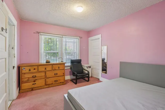 a bed room with a bed and a chair